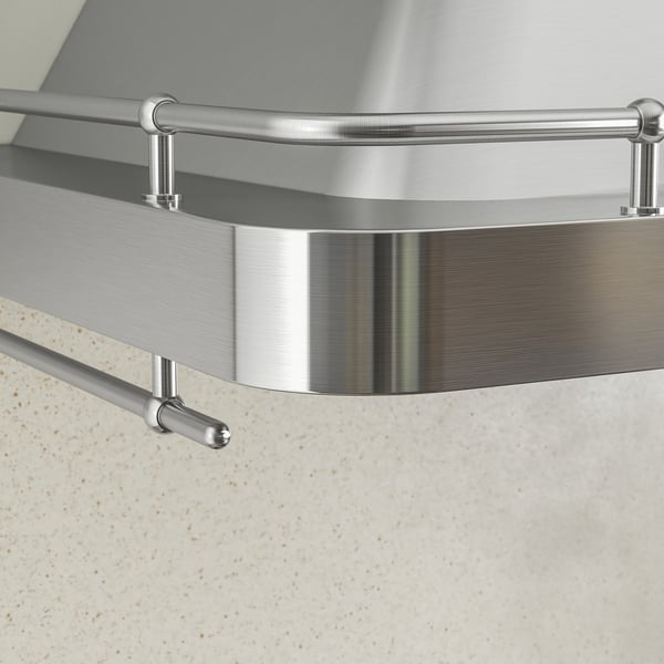 Emhætte i rustfrit stål med slankt design og poleret finish monteret på væggen. Afrundede kanter og metalliske støttebeslag.