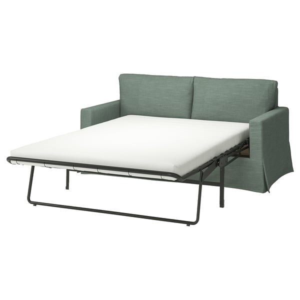 Grøn sovesofa med hvid madras, slankt design, konvertibel for komfort.