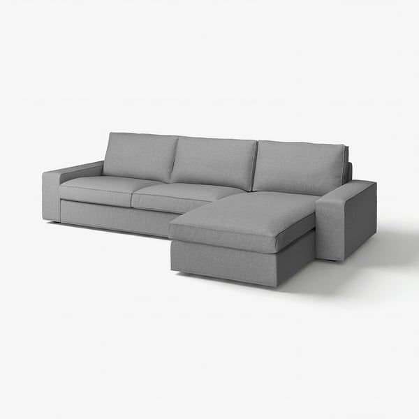 En grå L-formet stofsofa med bløde puder, designet til komfort og afslapning. En chaiselong og aftagelige armlæn.