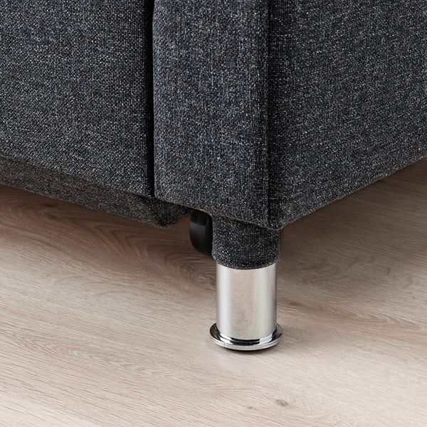 Mørk stofsofa med kromben, robust og moderne design.