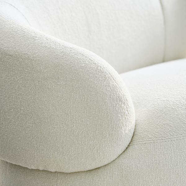 Et nærbillede af en blød, polstret pude med blide, fejede konturer, der fremhæver dens bløde, luksuriøse tekstur og elegante design.