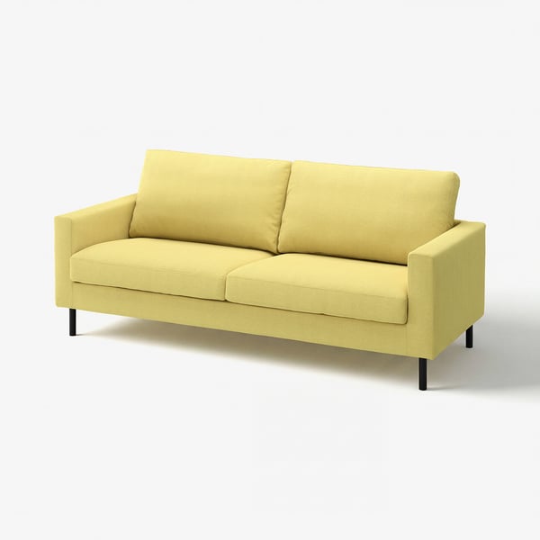 En lysegrøn SALTSJÖBADEN-sofa med rene linjer og tilspidsede ben, med bløde puder og et vaskbart betræk.