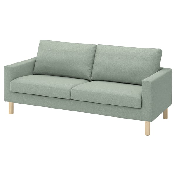 Grøn genbrugt polyestersofa med lette træben. Moderne design.