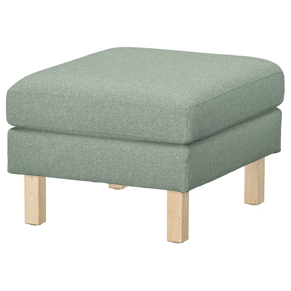 Grøn fodskammel med træben, perfekt til at hvile fødder eller ekstra siddeplads, enkelt og rent design.