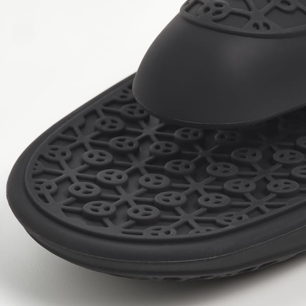 Sort silikone ovnhandske med indviklet tekstureret design for greb. Cirkulær åbning til ophængning.