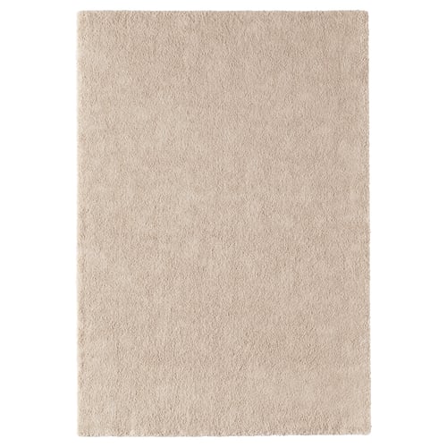 Et beige STOENSE-tæppe, rektangulært, blødt, tykt gulvmåtte lavet af polypropylen, ideel til komfort.