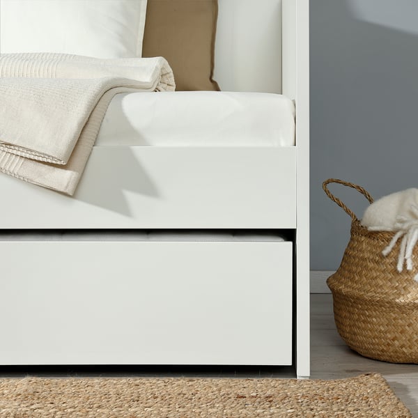 Hvid daybed med trilleopbevaring nedenunder for ekstra soveplads.