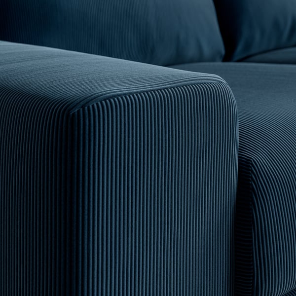 Close-up af VIMLE sofaens armlæn, der fremhæver det teksturerede, ribbede mørkeblå fløjlsstof og bløde, indbydende polstring.