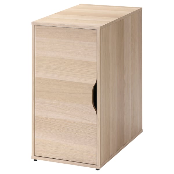 An ALEX wooden cabinet in light oak. It has one door with a black handle, a rectangular shape, and a sleek design.