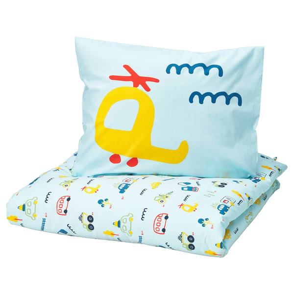 A BARNDRÖM kids pillow in blue with a yellow monster design and various toy prints. It is square-shaped, made from 100% cotton.