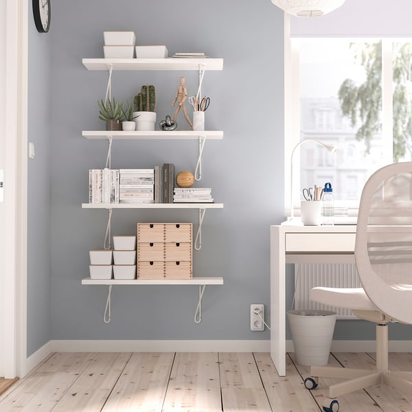Home office: BERGSHULT shelf with books & plants. Desk by window. Light wood floor, blue-grey walls.