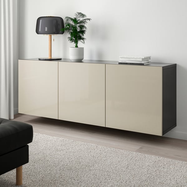 BESTÅ wall cabinet, lamp, plant, books; complements minimalist living space.