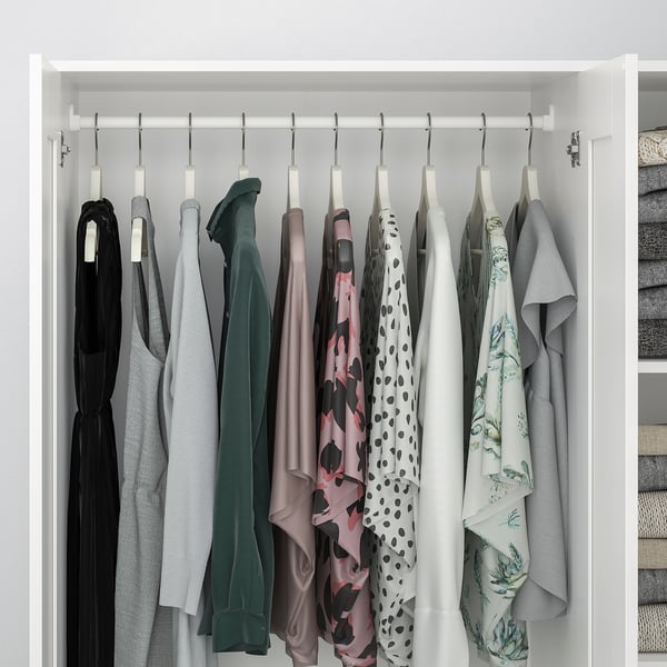 A white wardrobe with clothes rail, shelves, mirror door, safety fitting.