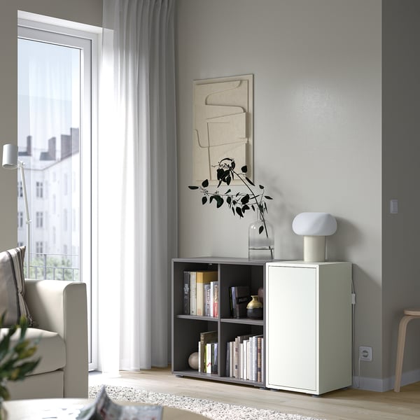 Minimalist living room with EKET storage, books, lamp, window, decor.