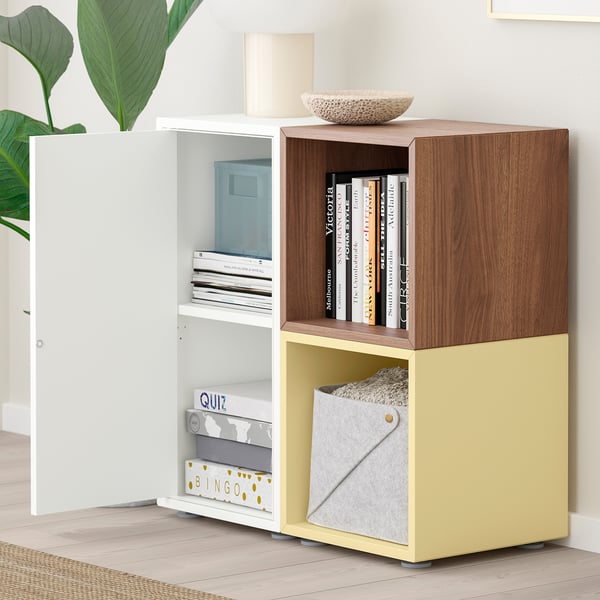 Modern storage unit with shelves and cabinets, displaying books, games, and a bowl.