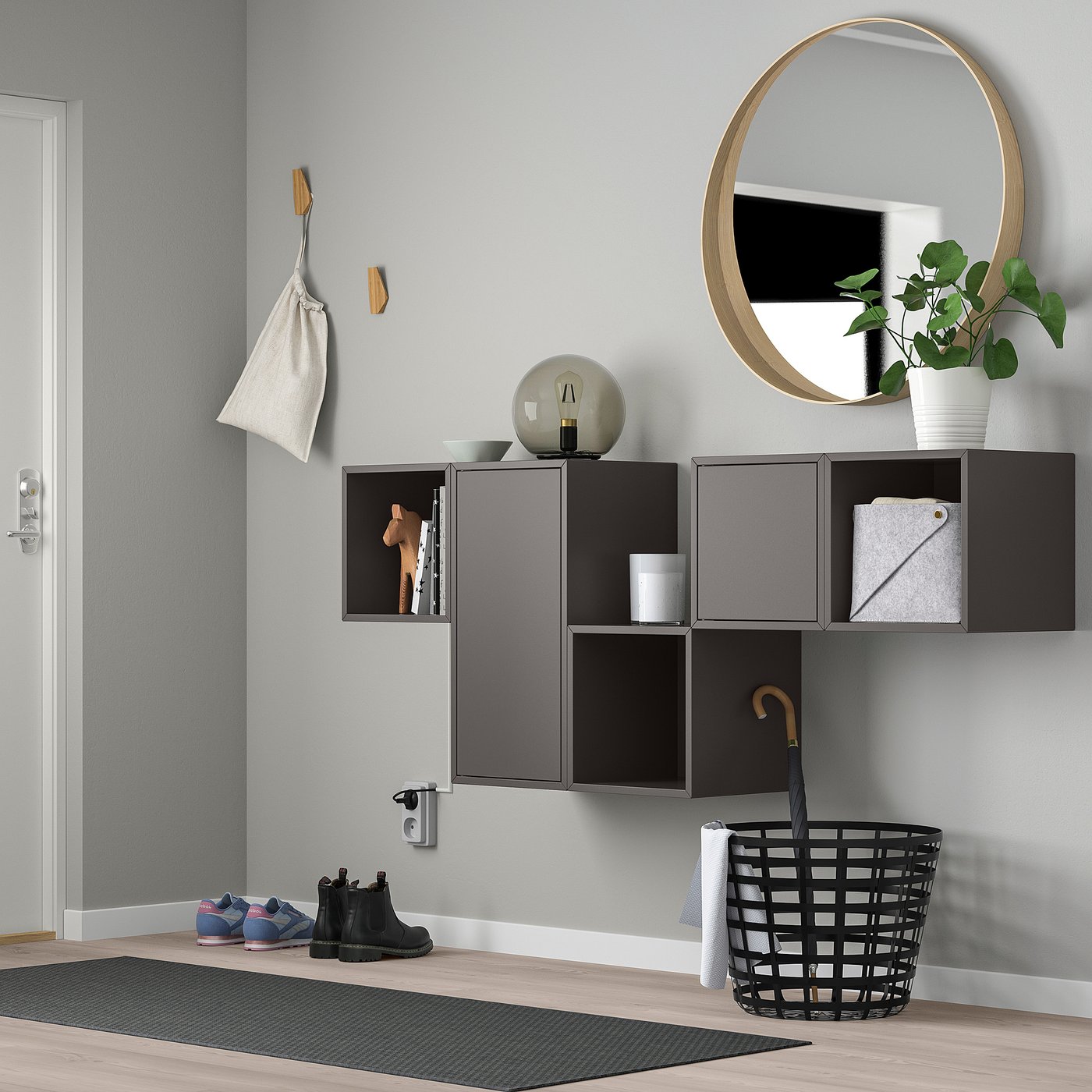 Modern entryway with EKET shelves, mirror, plant, and hooks.