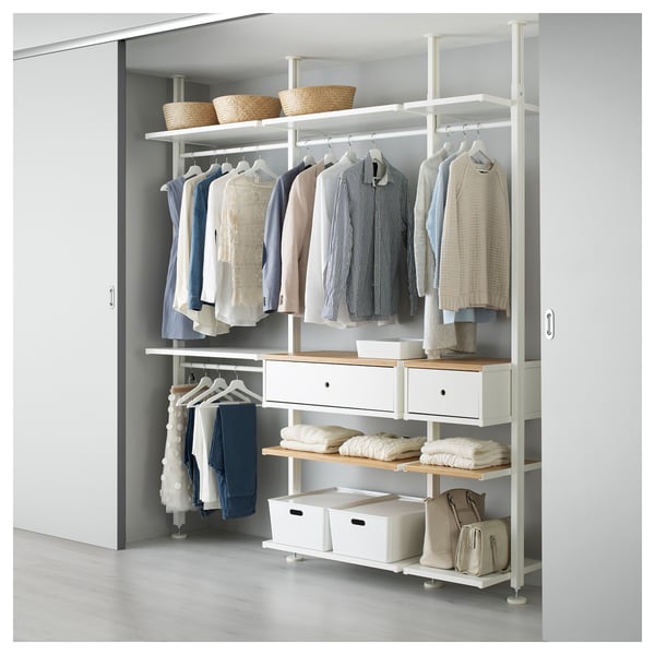 A white ELVARLI storage unit with shelves and drawers. It has oatmeal-colored clothes and accessories, emphasising a clean and organised look.