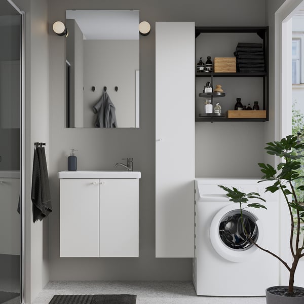 Modern bathroom with ENHET cabinet, mirror, and dryer. Sleek, compact, minimalist design.