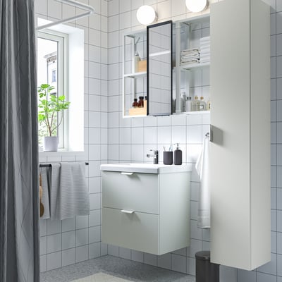 Modern bathroom with white fixtures, grey tiles, and minimalist design.