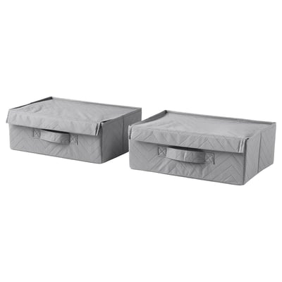 Two light grey fabric storage boxes with handles, rectangular and lid-covered, likely for organising items.