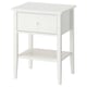 A white GULLABERG bedside table with a single drawer and an open shelf. It clean lines and elegant details, made of acrylic paint and fibreboard.