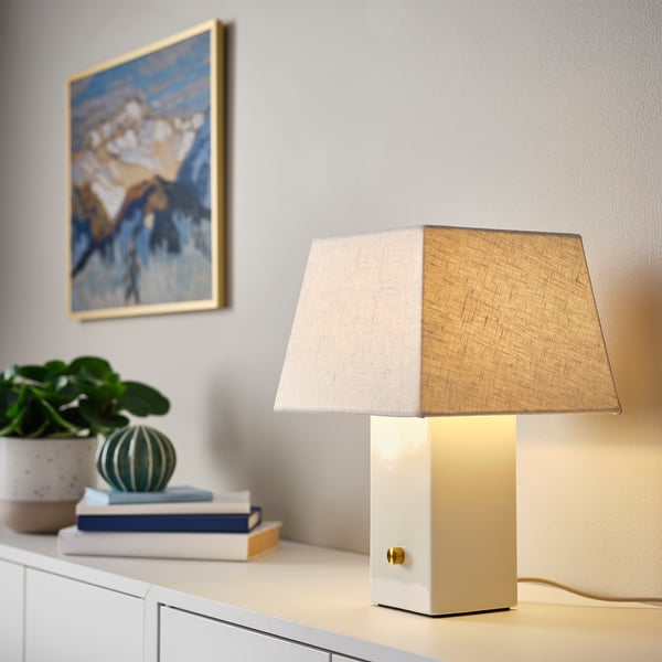 HALGATT table lamp in white ceramic with linen shade and brass knob.
