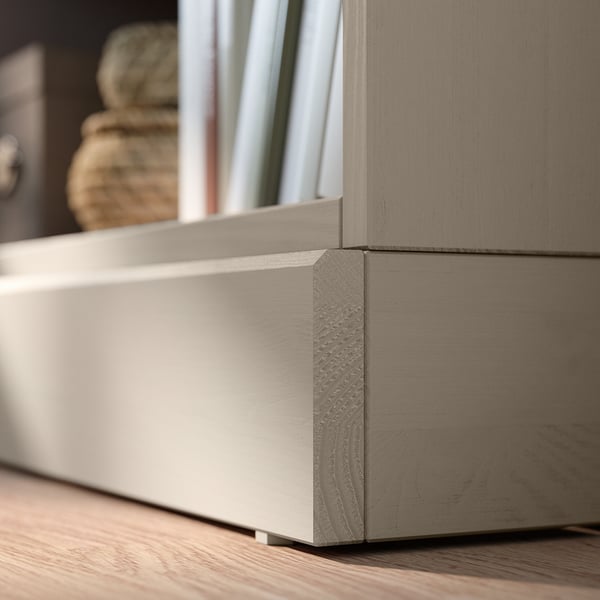 A corner of light brown HAVSTA pine cabinet with straight design lines, featuring two shelves.