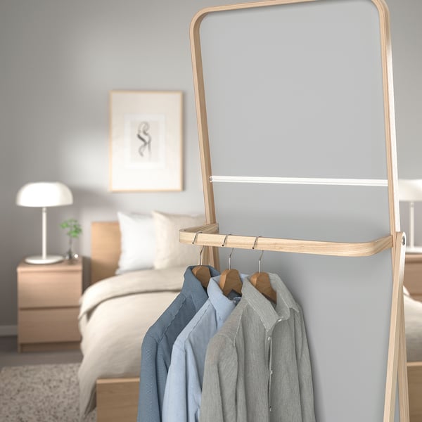 Wooden clothing rack with mirror; reflects and holds clothes behind for easy morning access.