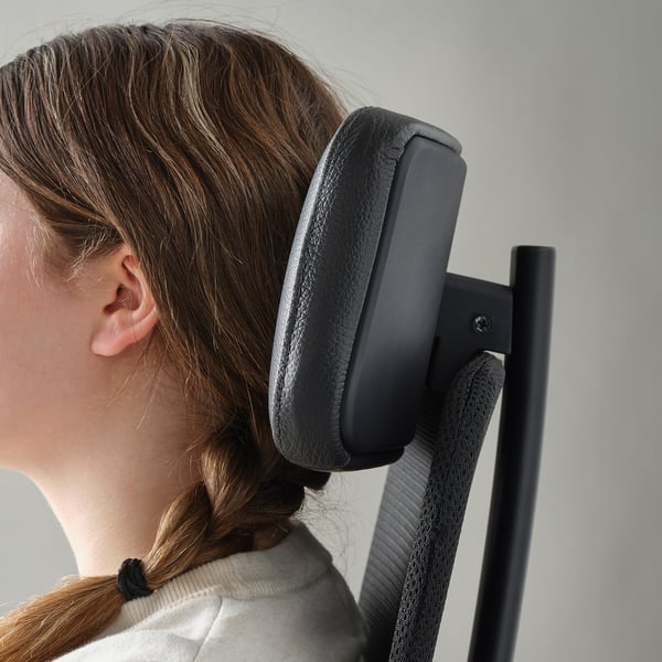 Image shows a person sitting in an ergonomic office chair with adjustable headrest.