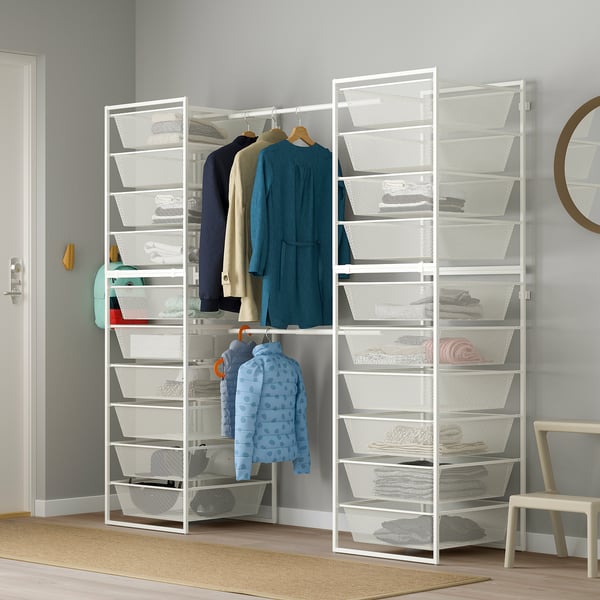 White JONAXEL wardrobe with mesh shelves, hanging rails, and blue jacket. Includes mirror, hooks, and chair.