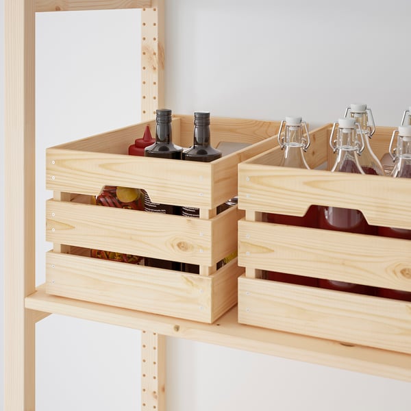 Wooden storage crates on shelves holding bottles and cans, showcasing organised storage for kitchen or garage.