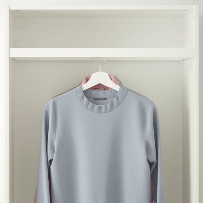 A light grey sweater hangs in a wardrobe on a white clothes rail, showcasing its neat organisation and storage functionality in a shallow frame.