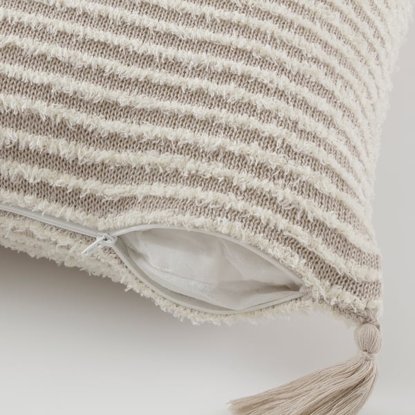 Thick textured cushion with stripes and fringe. Hidden zip for easy cover removal.