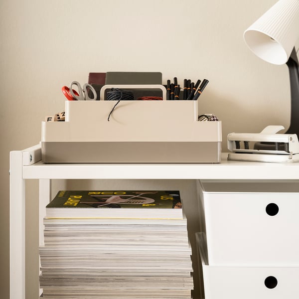 KUGGIS desk organiser, two-layered with top handle, stores small items and laptors. White, plastic. Fits well on surfaces beside a lamp and books.