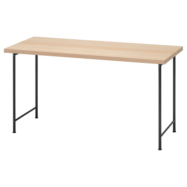 An IKEA LAGKAPTEN desk with light wooden top and black metal legs.