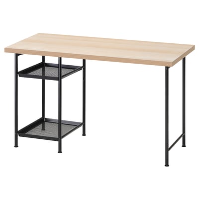 An IKEA LAGKAPTEN desk with a light-colored tabletop and black metal legs and shelves. It a sleek, modern design with two mesh shelves for storage.
