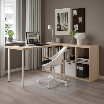 Modern home office with LAGKAPTEN light wood desk & white chair; well-organized with computer, lamp, books, and plants.