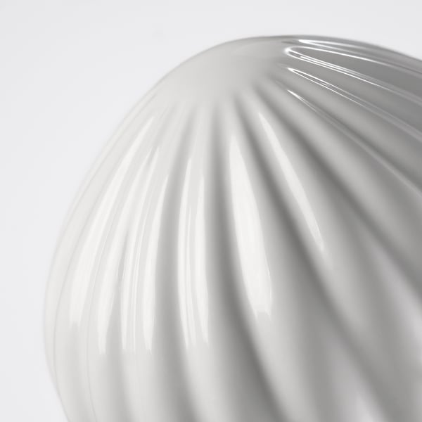Ceramic finial with grooved, smooth texture. Close-up highlights fine details and craftsmanship.
