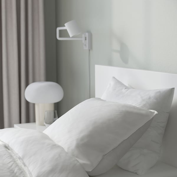 Minimalist bed with tall headboard and adjustable sides, perfect for reading or watching tv.