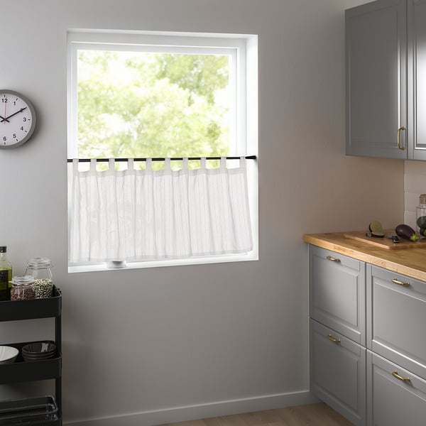 Recycled polyester MATILDA curtains in light blue, floor-length for kitchen privacy, complementing grey cabinets and kitchenware.