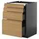 A modern kitchen unit called METOD with light oak drawers and black cabinet, featuring four drawers and one pull-out work space.