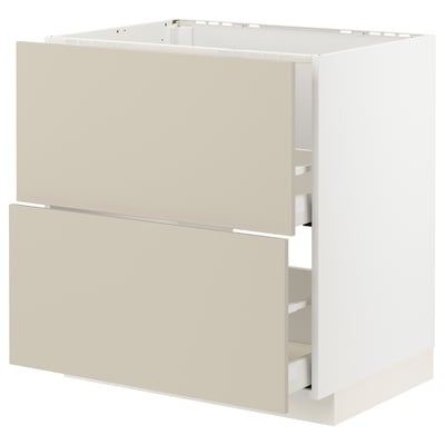 An off-white METOD kitchen cabinet with beige havstorp fronts, featuring a smooth, rectangular design with integrated drawers.