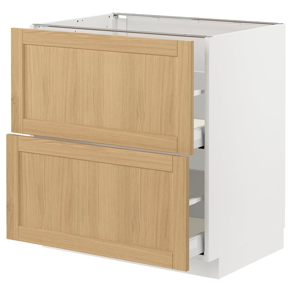 A white METOD kitchen cabinet with light oak drawers and door.