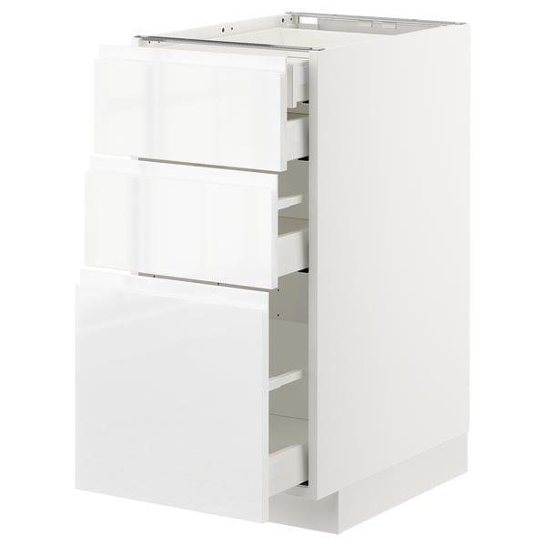 White high gloss kitchen cabinet with three open drawers.