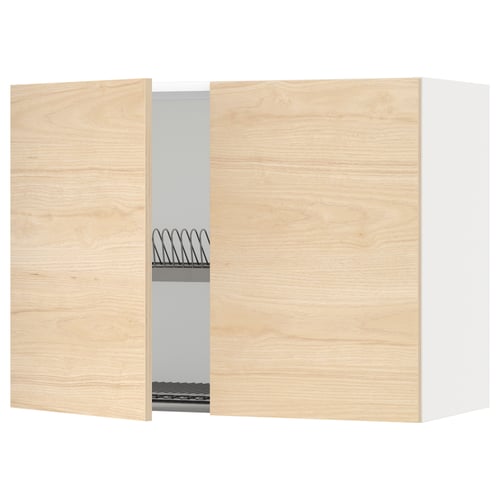 A light wood-colored kitchen cabinet with a wire dish drainer and a single open door, part of the METOD kitchen system.