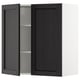 A black stained lerhyttan METOD kitchen wall cabinet with one door open, revealing an adjustable shelf inside.