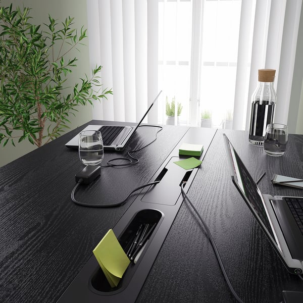 Modern high conference table with built-in footrest, power outlets, and cable management. Perfect for meetings with sitting or standing options.