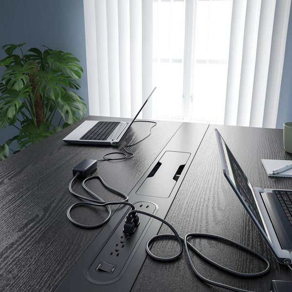 Modern high conference table with built-in power outlets and cable management, perfect for meetings and co-working spaces.