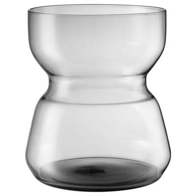 The OMTÄNKSAM clear glass vase. Its design has a uniquely curved, asymmetrical shape, perfect for holding flowers or as a decorative piece.