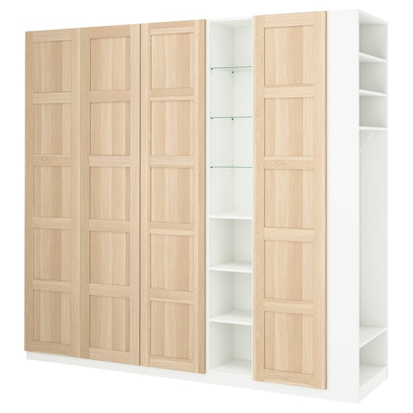 A light-colored wooden PAX wardrobe with white accents, combining closed and open sections for storage.